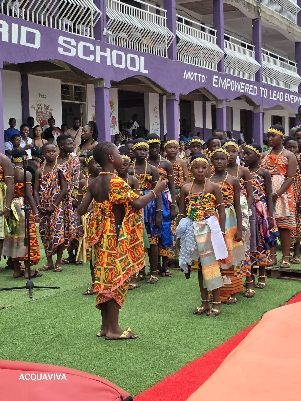 Students in traditional attire during cultural presentation